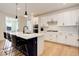 Modern kitchen featuring white cabinets, a center island, and stainless steel appliances at 7029 Sagerock St, Castle Pines, CO 80108