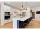 Stylish kitchen with white cabinets, an island with seating, and stainless steel appliances at 7029 Sagerock St, Castle Pines, CO 80108