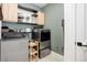 Well-organized laundry room featuring updated appliances and plentiful storage for a functional space at 7029 Sagerock St, Castle Pines, CO 80108