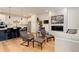 Open-concept living room and kitchen with modern finishes, white cabinets, and comfortable seating at 7029 Sagerock St, Castle Pines, CO 80108