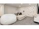 Spacious living area with a climbing wall, plush seating and entertainment center at 7029 Sagerock St, Castle Pines, CO 80108