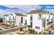 Aerial view of a modern townhome community with manicured landscaping and a welcoming entrance at 1169 S Reed Way, Lakewood, CO 80232