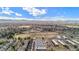 Expansive aerial view showcasing the neighborhood with mature trees, multiple baseball fields and mountain views at 1169 S Reed Way, Lakewood, CO 80232