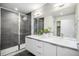 Modern bathroom featuring double sinks, a sleek glass-enclosed shower, and contemporary fixtures at 1169 S Reed Way, Lakewood, CO 80232