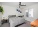 Cozy bedroom featuring a ceiling fan, a desk, a window with blinds, and neutral décor at 1169 S Reed Way, Lakewood, CO 80232