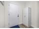 Clean entryway featuring a white door, storage cabinet, and wood-look flooring at 1169 S Reed Way, Lakewood, CO 80232