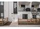 Modern townhouse exterior with black framed windows, white siding, a small patio area, and front door at 1169 S Reed Way, Lakewood, CO 80232