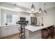 Modern kitchen with white countertops, stainless steel appliances, pendant lighting, and breakfast bar at 1169 S Reed Way, Lakewood, CO 80232