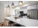 Modern kitchen features stainless steel appliances, sleek countertops, and contemporary pendant lighting at 1169 S Reed Way, Lakewood, CO 80232