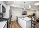 Modern kitchen with stainless steel appliances, breakfast bar, and a dining area at 1169 S Reed Way, Lakewood, CO 80232