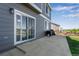 Back patio with sliding glass door, BBQ grill, and view of the well-maintained backyard at 14803 E 119Th Ave, Commerce City, CO 80603