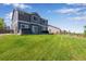 Spacious backyard with lush lawn, hot tub, and wood fence offering a private outdoor space at 14803 E 119Th Ave, Commerce City, CO 80603