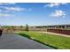 Backyard features a concrete patio, green lawn, and wood fence for privacy at 14803 E 119Th Ave, Commerce City, CO 80603