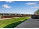 Backyard features a concrete patio, green lawn, wood fence, a hot tub, and a seating area at 14803 E 119Th Ave, Commerce City, CO 80603