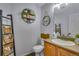 This half bathroom features wood-look vinyl floors, and cute decor at 14803 E 119Th Ave, Commerce City, CO 80603