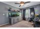 Bedroom featuring an aquarium, a ceiling fan, and carpeted floors at 14803 E 119Th Ave, Commerce City, CO 80603