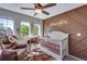Charming Bedroom with unique wall decor, rocking chair, and crib at 14803 E 119Th Ave, Commerce City, CO 80603