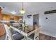 Dining area with a view into the kitchen and access to the laundry room at 14803 E 119Th Ave, Commerce City, CO 80603