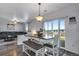 Bright dining area with a pendant light, bench seating, and access to the backyard at 14803 E 119Th Ave, Commerce City, CO 80603
