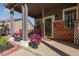 Welcoming front porch with decorative flower pots, brick accents, and a charming 