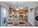 Open kitchen and dining area with stainless steel appliances and ample counter space at 14803 E 119Th Ave, Commerce City, CO 80603