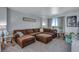This lovely living room boasts a large plush sectional sofa and a window view at 14803 E 119Th Ave, Commerce City, CO 80603