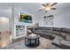 Cozy living room with a fireplace, large sectional, and built-in shelving with decor at 14803 E 119Th Ave, Commerce City, CO 80603