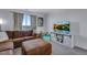 This living room is cozy with a large sectional sofa and a flat-screen television at 14803 E 119Th Ave, Commerce City, CO 80603