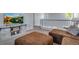 Open-concept living room area features a plush brown sectional and upstairs railing at 14803 E 119Th Ave, Commerce City, CO 80603
