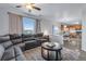 Open-concept living room with a large sectional, next to the kitchen and dining area at 14803 E 119Th Ave, Commerce City, CO 80603