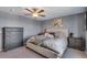 Comfortable bedroom features neutral decor, a ceiling fan, and lots of natural light at 14803 E 119Th Ave, Commerce City, CO 80603