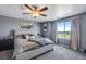 Spacious bedroom includes a ceiling fan, large window, and stylish decor at 14803 E 119Th Ave, Commerce City, CO 80603