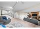 Cozy basement living area with a brick fireplace, two sofas, and staircase to upper floors at 6742 Cole Cir, Arvada, CO 80004