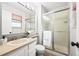 Bright bathroom featuring a glass-enclosed shower, vanity with sink, and neutral finishes, and a towel at 6742 Cole Cir, Arvada, CO 80004