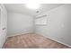 Spare bedroom with neutral paint, neutral carpet, closet with bi-fold doors, and a single window at 6742 Cole Cir, Arvada, CO 80004