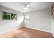 Well-lit bedroom with hardwood floors, a ceiling fan, and lots of natural light from two windows at 6742 Cole Cir, Arvada, CO 80004
