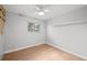 Minimalist bedroom with hardwood floors, a large window, and neutral walls providing a blank canvas at 6742 Cole Cir, Arvada, CO 80004