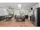 Modern kitchen with stainless appliances, island, white subway tile, breakfast nook, and access to the deck at 6742 Cole Cir, Arvada, CO 80004