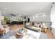 Bright, open-concept living room and kitchen with modern finishes and hardwood floors, filled with natural light at 6742 Cole Cir, Arvada, CO 80004