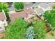 Aerial view of landscaped backyard with wood deck featuring outdoor seating and mature trees at 10301 Owens Cir, Broomfield, CO 80021