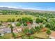 Aerial view of the neighborhood and backyard with mature trees and green grass at 10301 Owens Cir, Broomfield, CO 80021