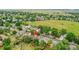 Aerial view of the neighborhood and backyard with mature trees and a fenced yard at 10301 Owens Cir, Broomfield, CO 80021