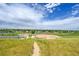 Ballfields surrounded by a grassy landscape, with houses visible in the distance under a cloudy sky at 10301 Owens Cir, Broomfield, CO 80021