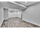 Spacious finished basement featuring wood-look flooring, recessed lighting and ample room for various activities at 10301 Owens Cir, Broomfield, CO 80021