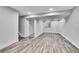 Finished basement with stylish wood-look tile flooring and recessed lighting, offering versatile living space at 10301 Owens Cir, Broomfield, CO 80021