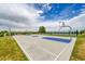 Outdoor basketball court with blue accents, surrounded by grass, fencing, and trees at 10301 Owens Cir, Broomfield, CO 80021