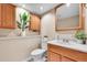 This half-bathroom offers a sink, toilet, storage cabinet, and is brightly lit at 10301 Owens Cir, Broomfield, CO 80021