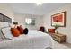 This is a bedroom with a white bed, colorful pillows, and natural light from the window at 10301 Owens Cir, Broomfield, CO 80021