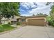 Charming split-level with a well-maintained lawn and driveway leading to an attached two-car garage at 10301 Owens Cir, Broomfield, CO 80021