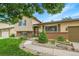 Welcoming split level with a well-manicured lawn and landscaped garden area at 10301 Owens Cir, Broomfield, CO 80021